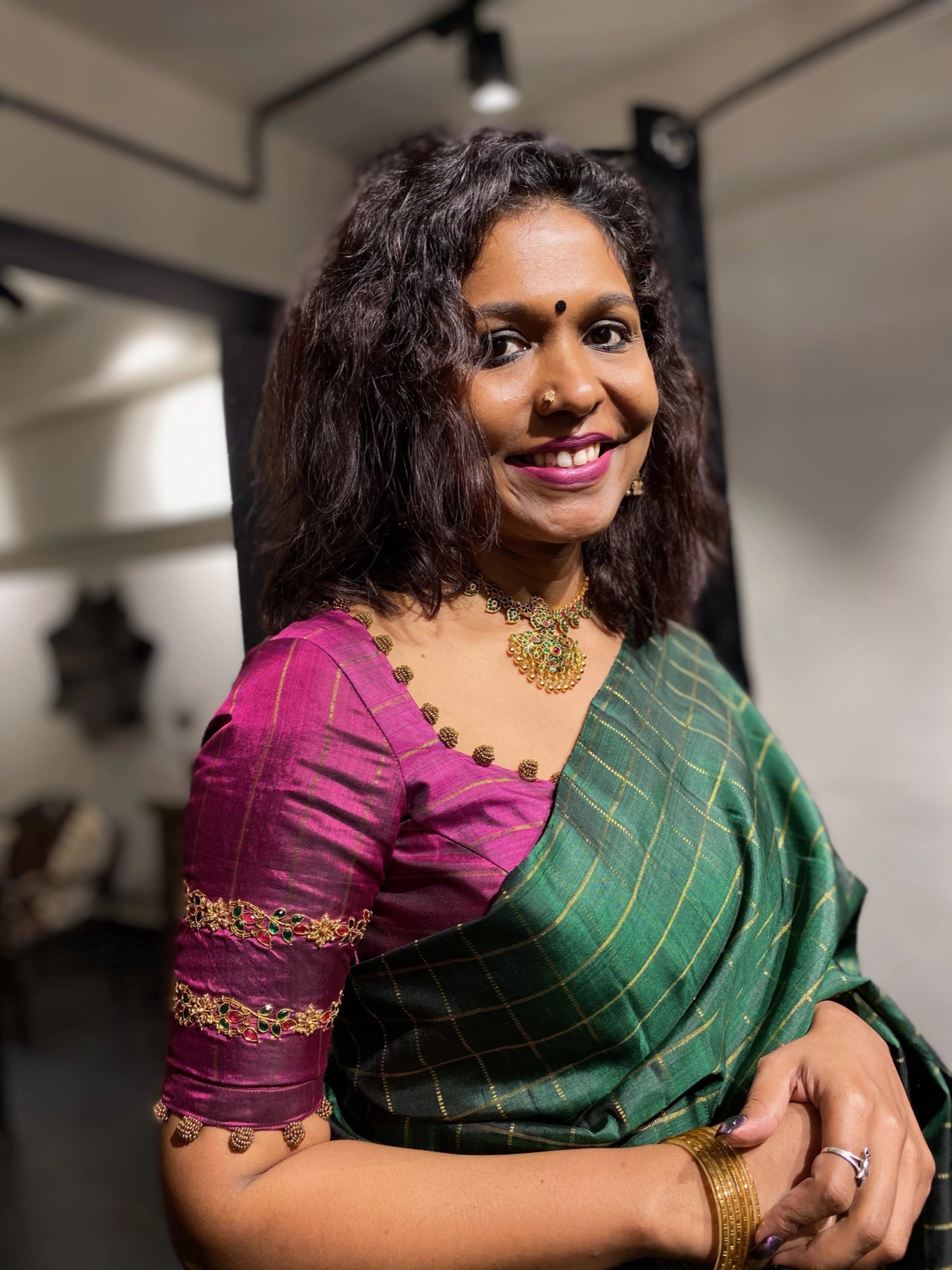 Sasi in a dark magenta silk blouse, handcrafted by team Archana Karthick.