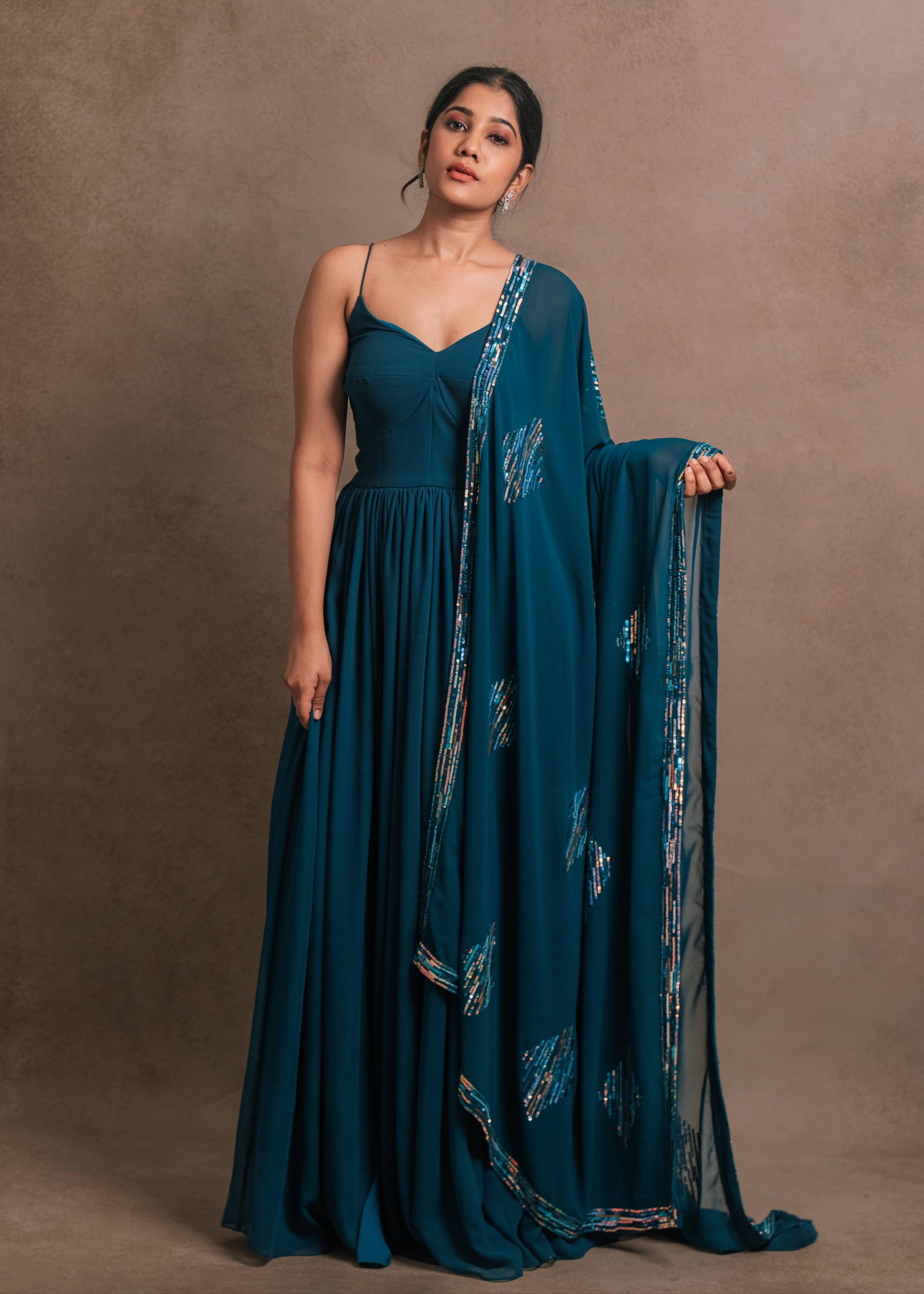 Showcasing front design in an egyptian blue georgette anarkali-kurti, featuring a sleek slit, paired with an intricately handcrafted georgette dupatta by team Archana Karthick.