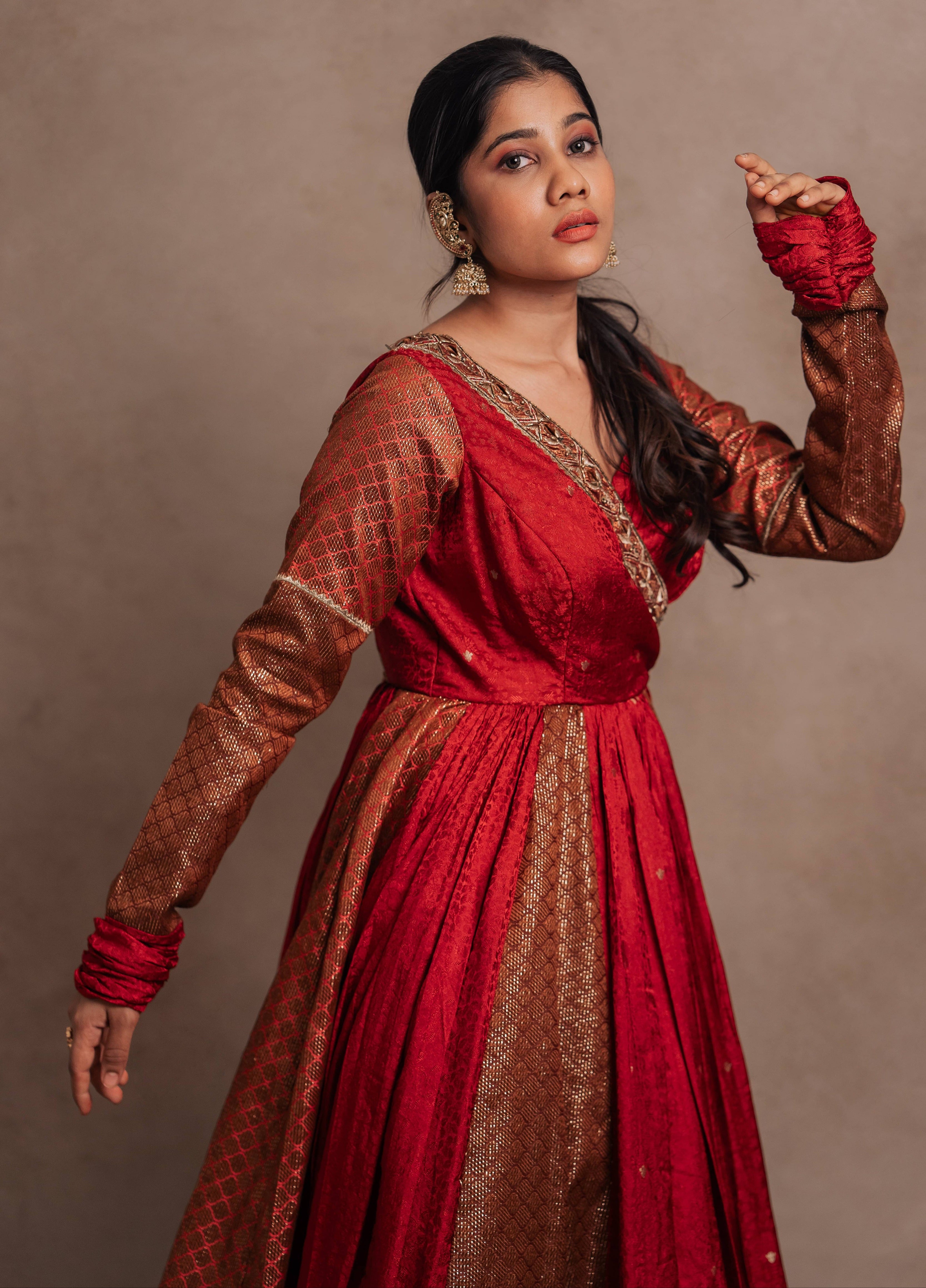 Sleeve design details of a Red-orange angrakha anarkali in banarasi tissue and silk paired with a sharara pant and a delicate tissue dupatta by team Archana Karthick