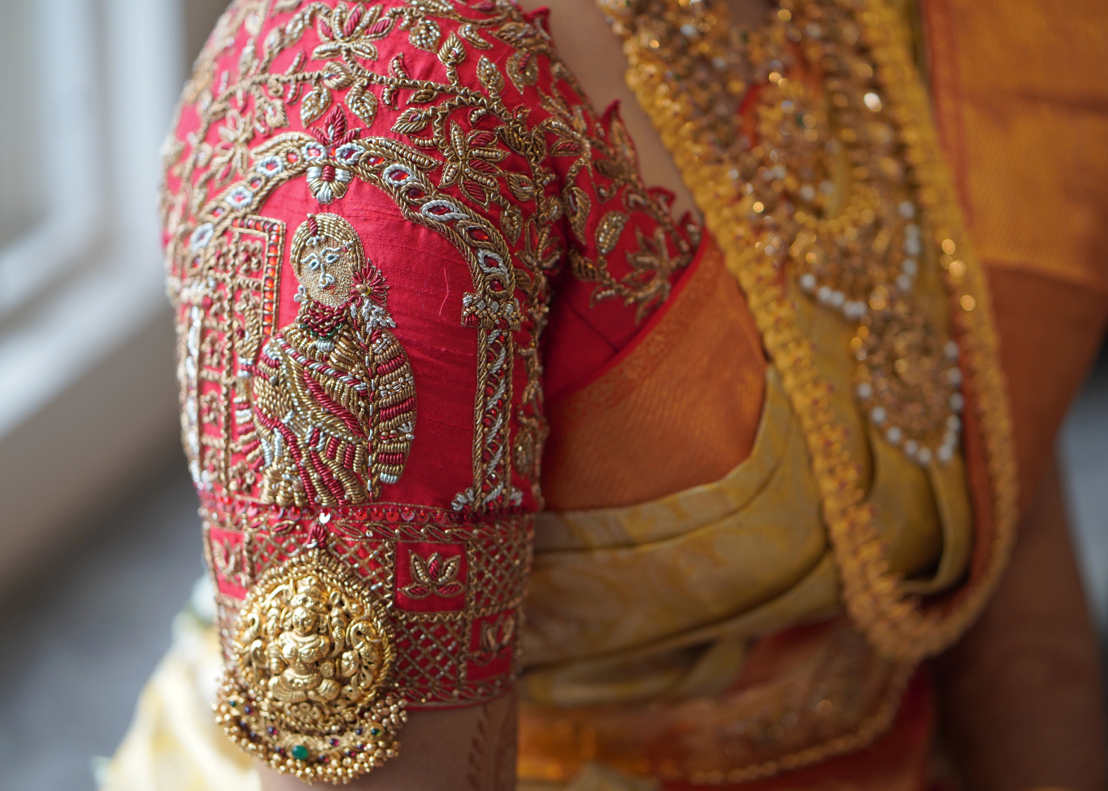 Sleeve of a concept red raw silk blouse and tulle veil handcrafted intricately with zardozi, beads, stones and sequins. Designed by Archana Karthick
