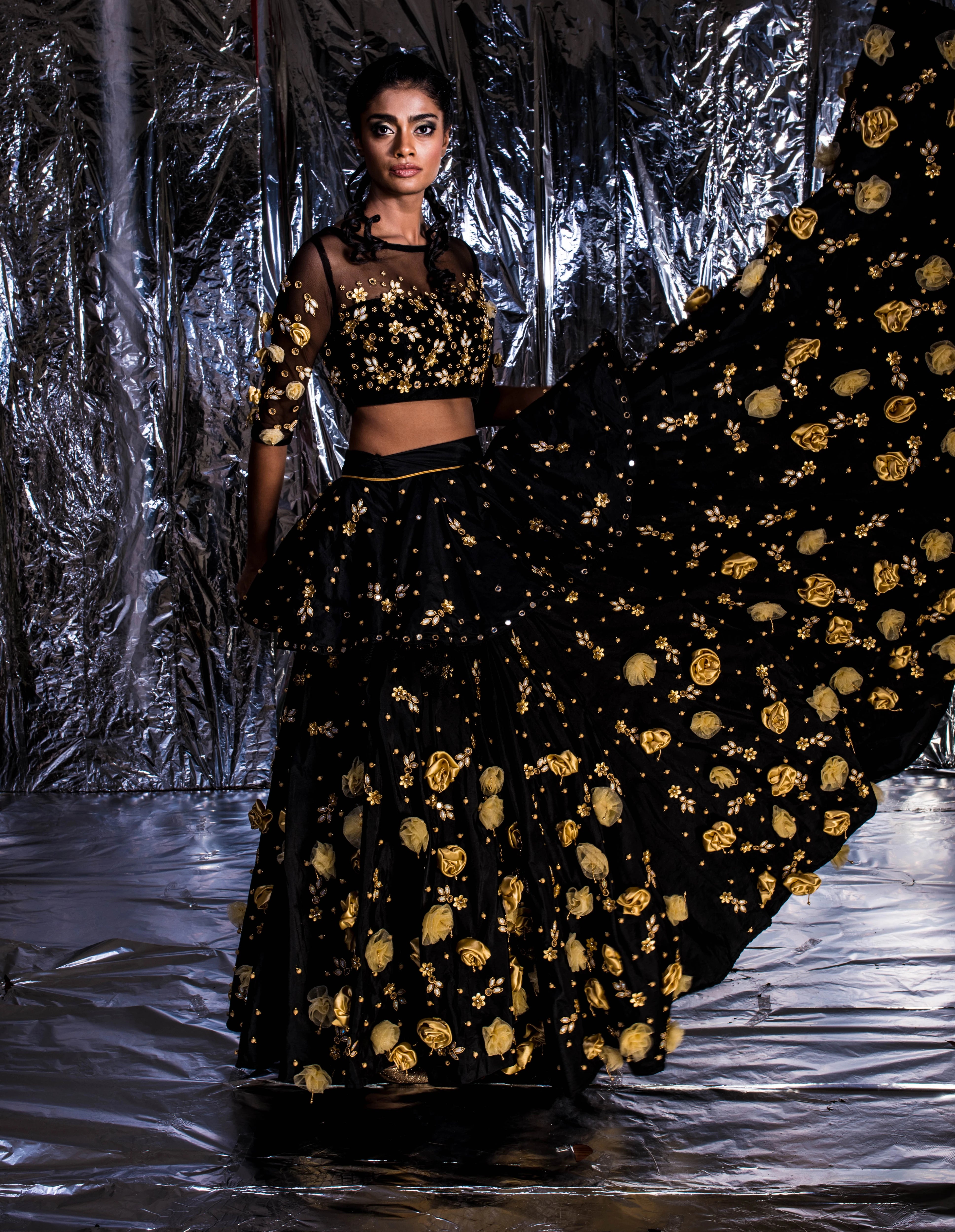 Supermodel Archana Akil Kumar doing supermodel things in a black taffeta lehenga with a gold georgette dupatta intricately handcrafted with appliques, pearls, mirror and beads.