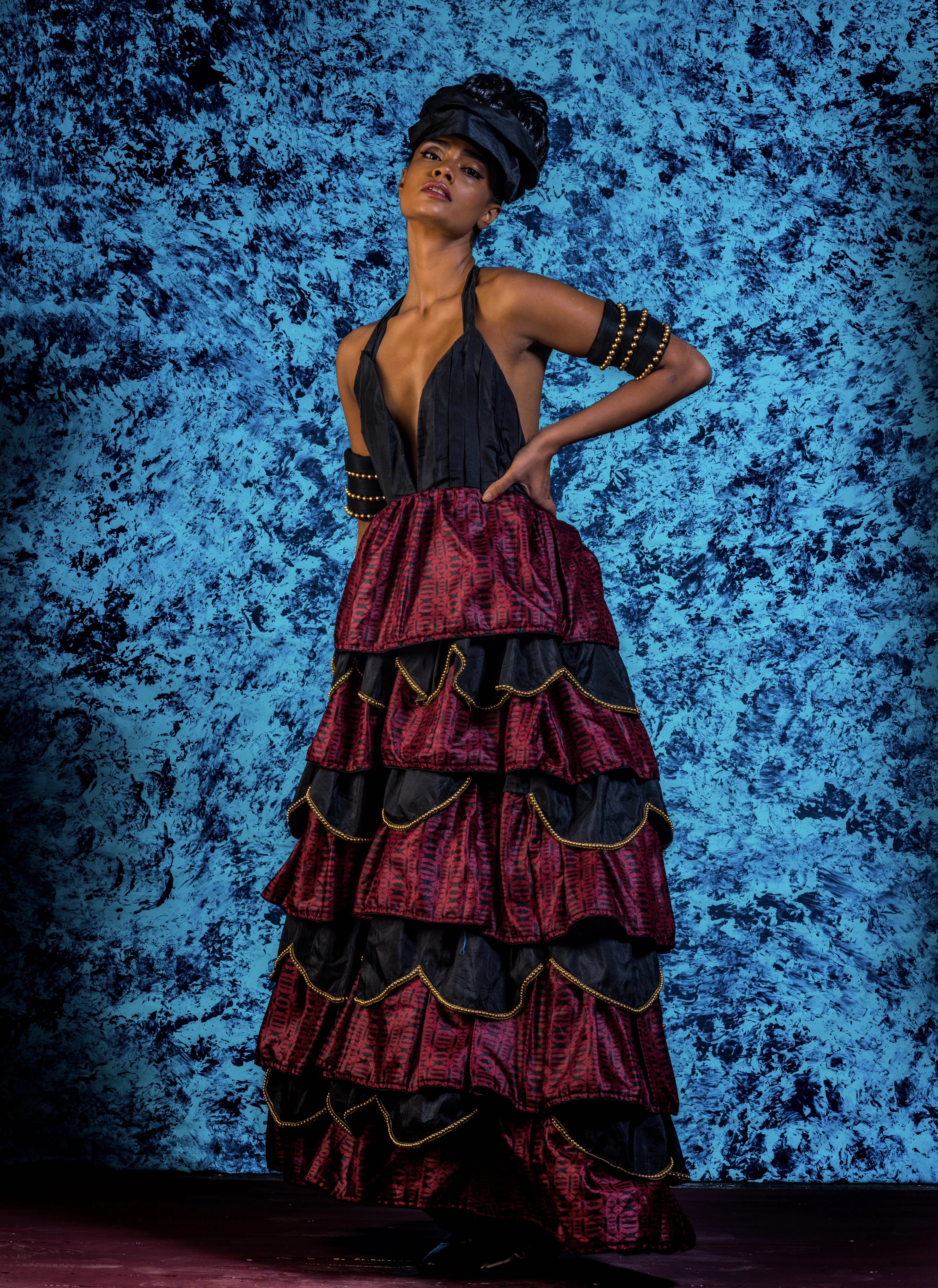Supermodel Archana Akil Kumar posing in a noir halterneck gown with a multi-tiered scalloped look. Partywear Gown.
