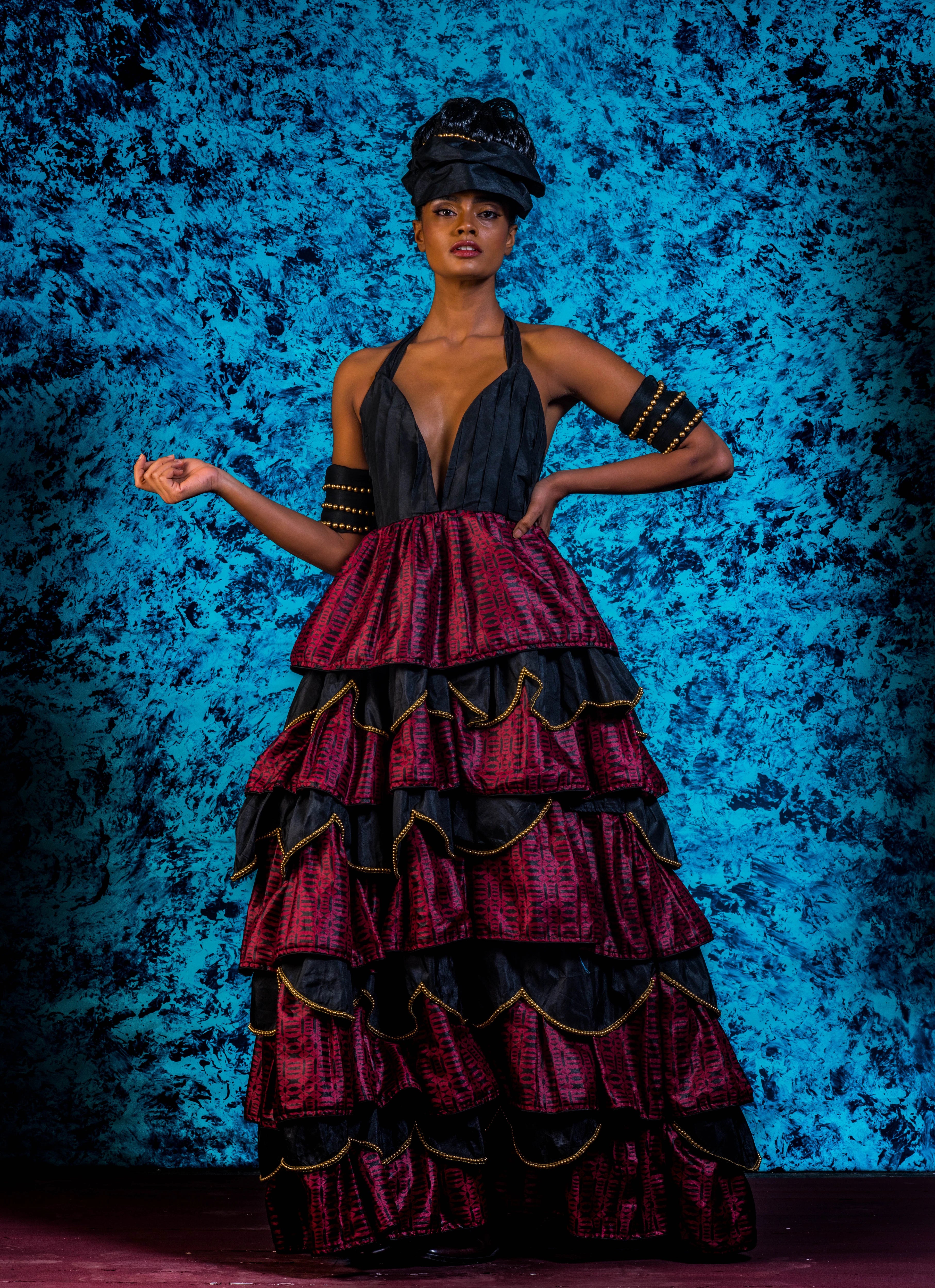 Supermodel Archana Akil Kumar posing stylishly in a noir halterneck gown with a multi-tiered scalloped look. Partywear Gown.