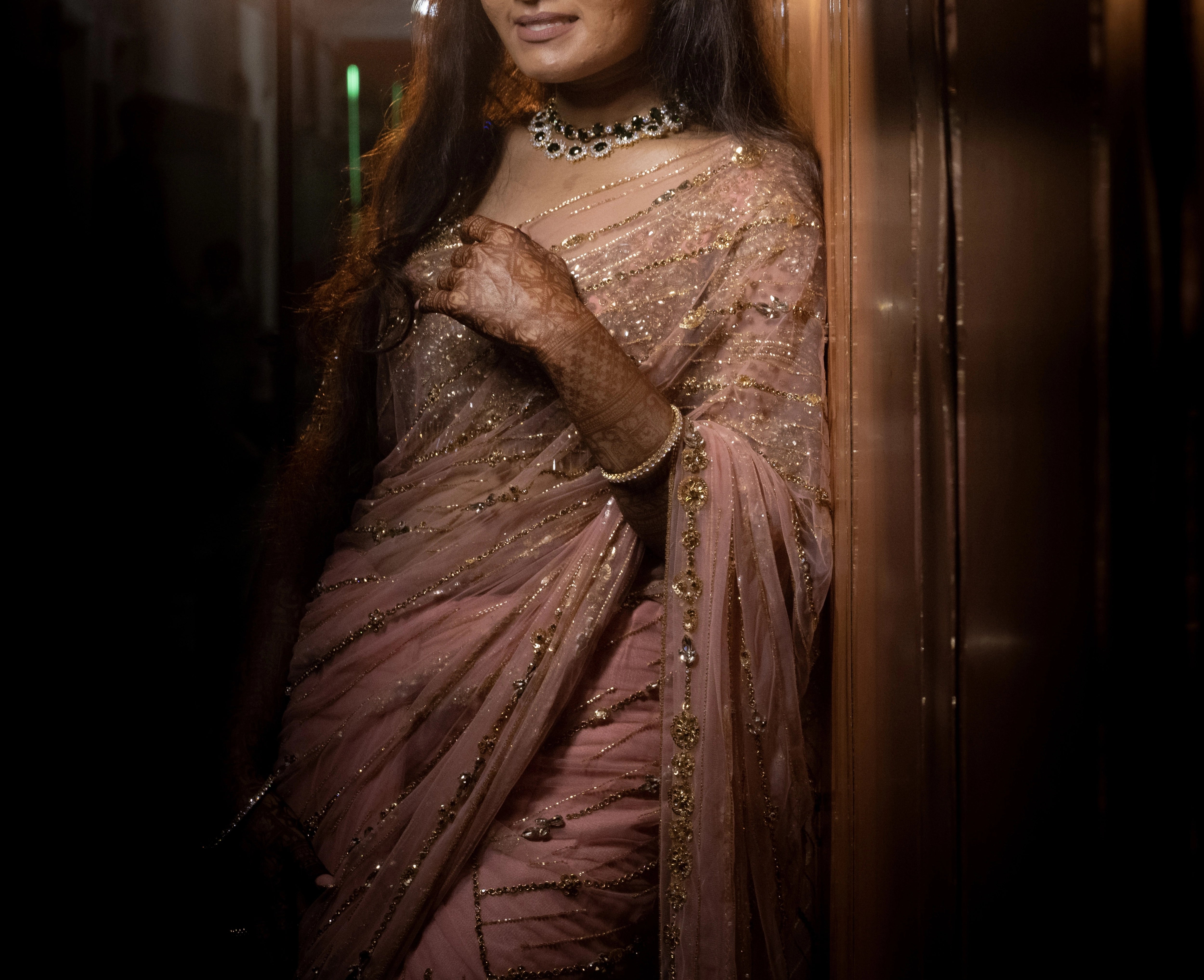 Vaishali from Dubai in a peach pink saree handcrafted by team Archana Karthick.
