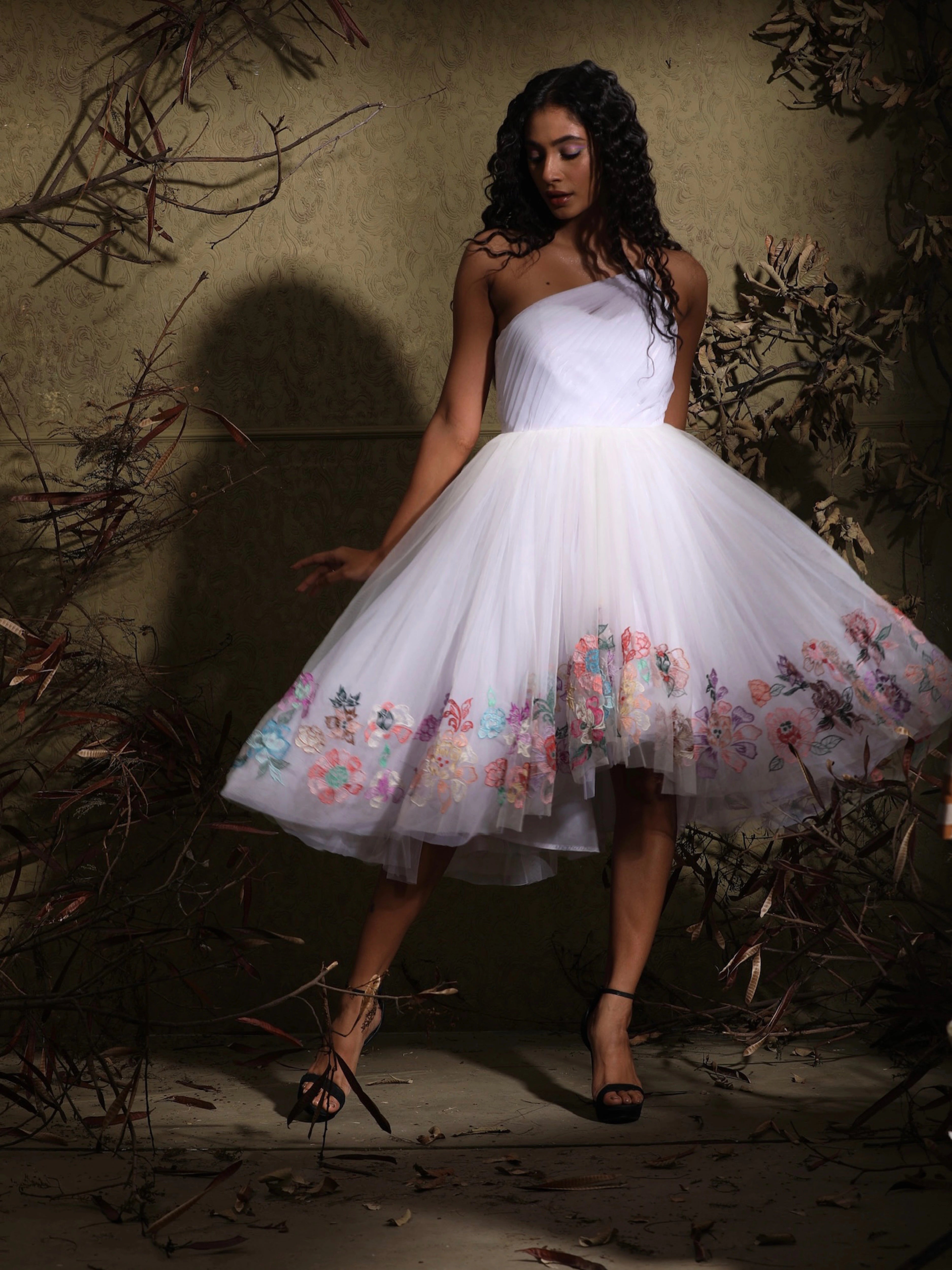 Miss India 2018 Anukreethy Vas in full length, wearing a white one-shoulder tulle dress with beautiful pastel floral intricacies, highlighting the elegance of Archana Karthick's designer collection.