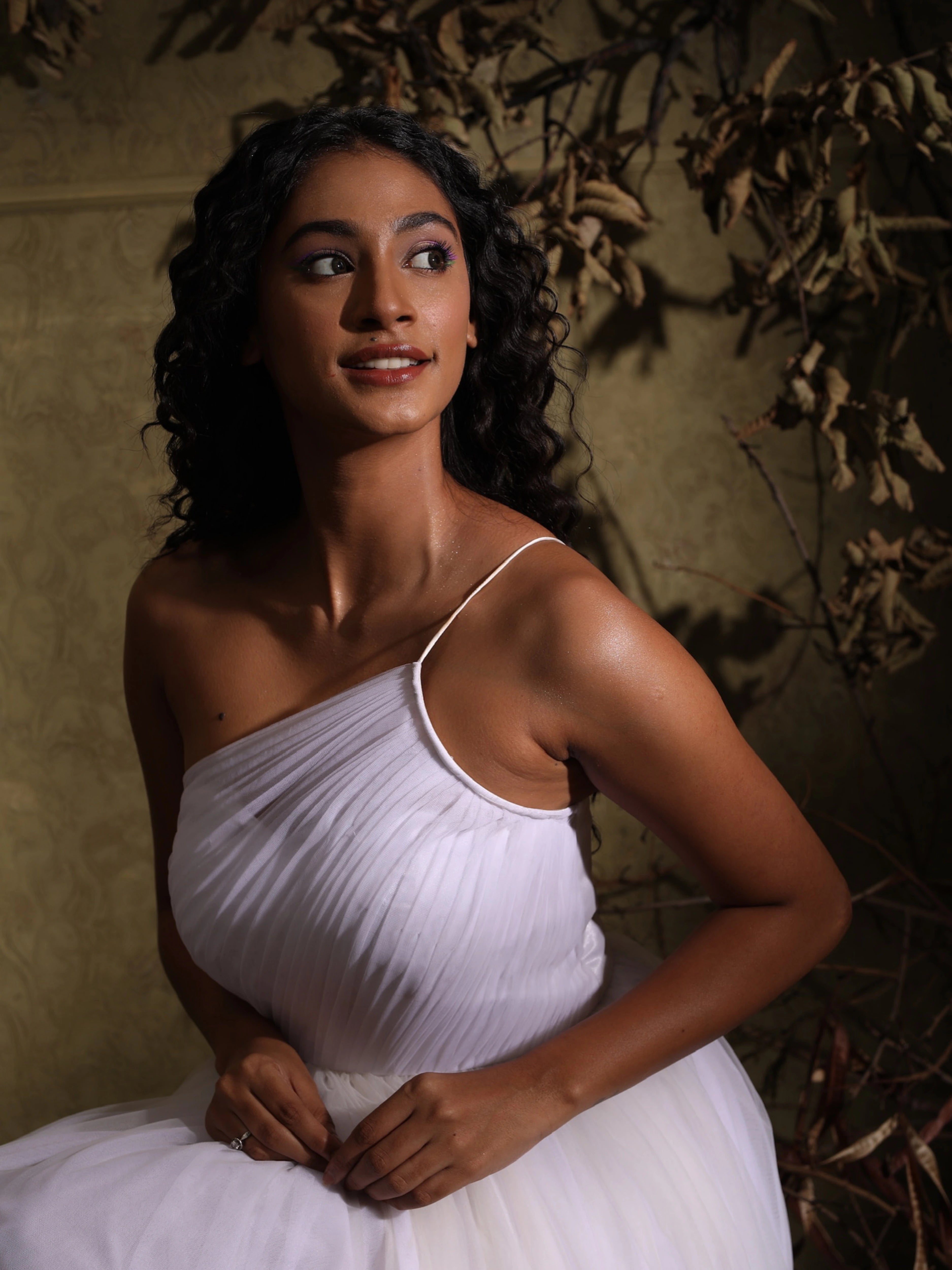 Close-up of Anukreethy Vas, Miss India 2018, in a white one-shoulder tulle dress by Archana Karthick, focusing on her radiant expression and the delicate top detail of the designer outfit.