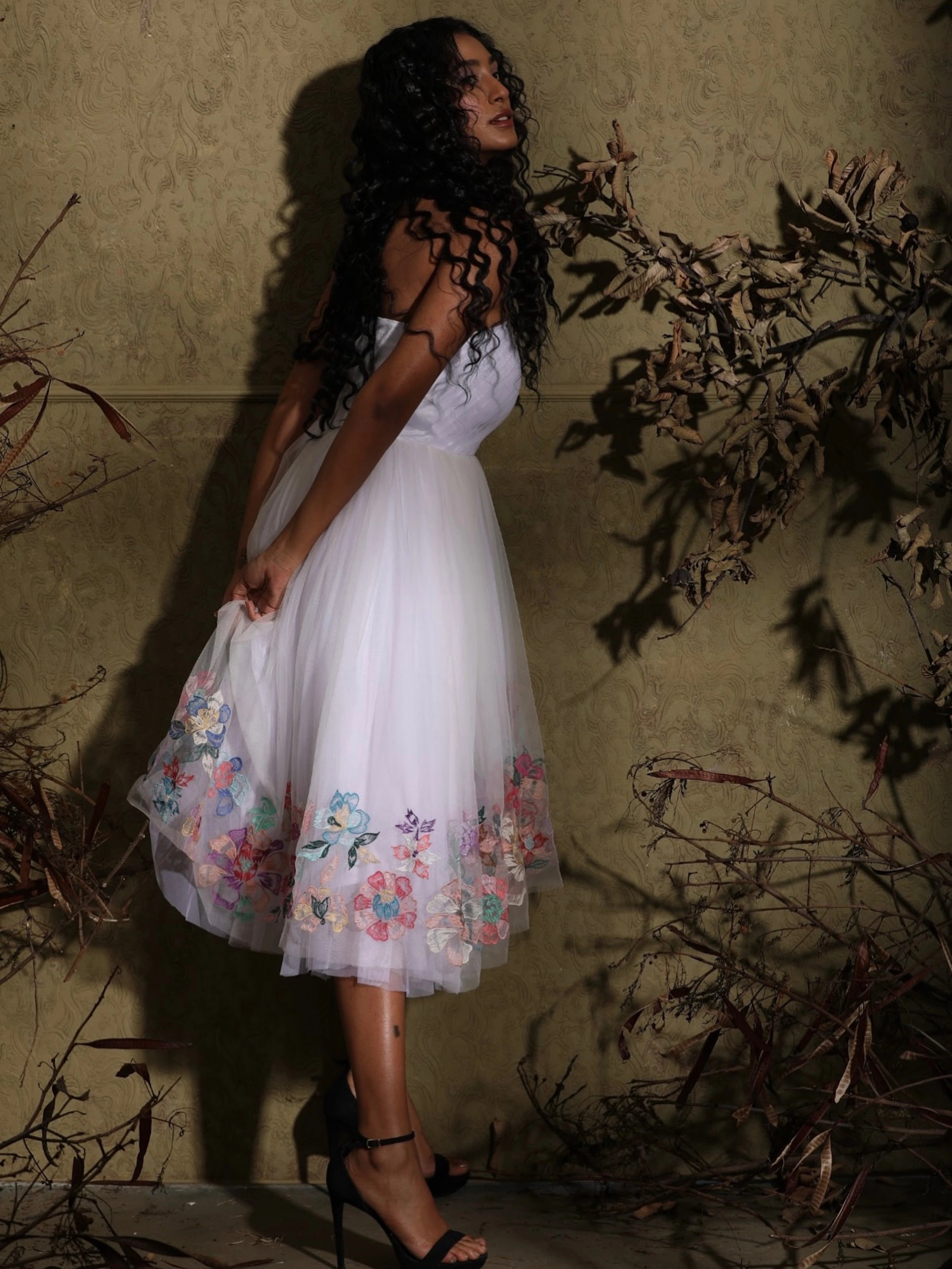 Full view of Anukreethy Vas, Miss India 2018, in a white one-shoulder tulle dress with elegant pastel floral embroidery, a sophisticated and celebrity-approved cocktail dress by Archana Karthick.