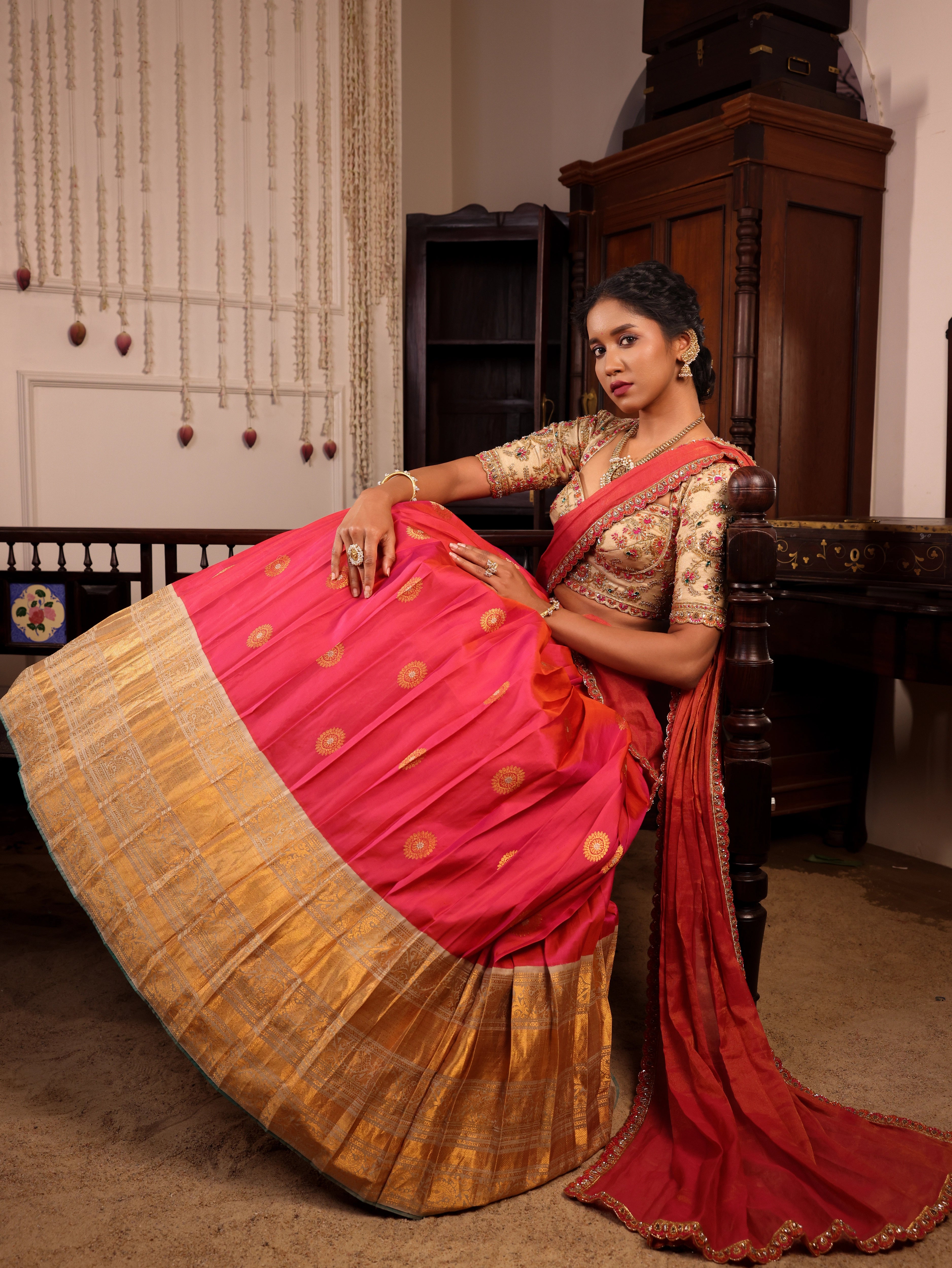 Model Gayathri Dhanasekar posing  in  ivory and pink  kanjeevaram silk half saree with jewelry by vummidi bangaru jewellers