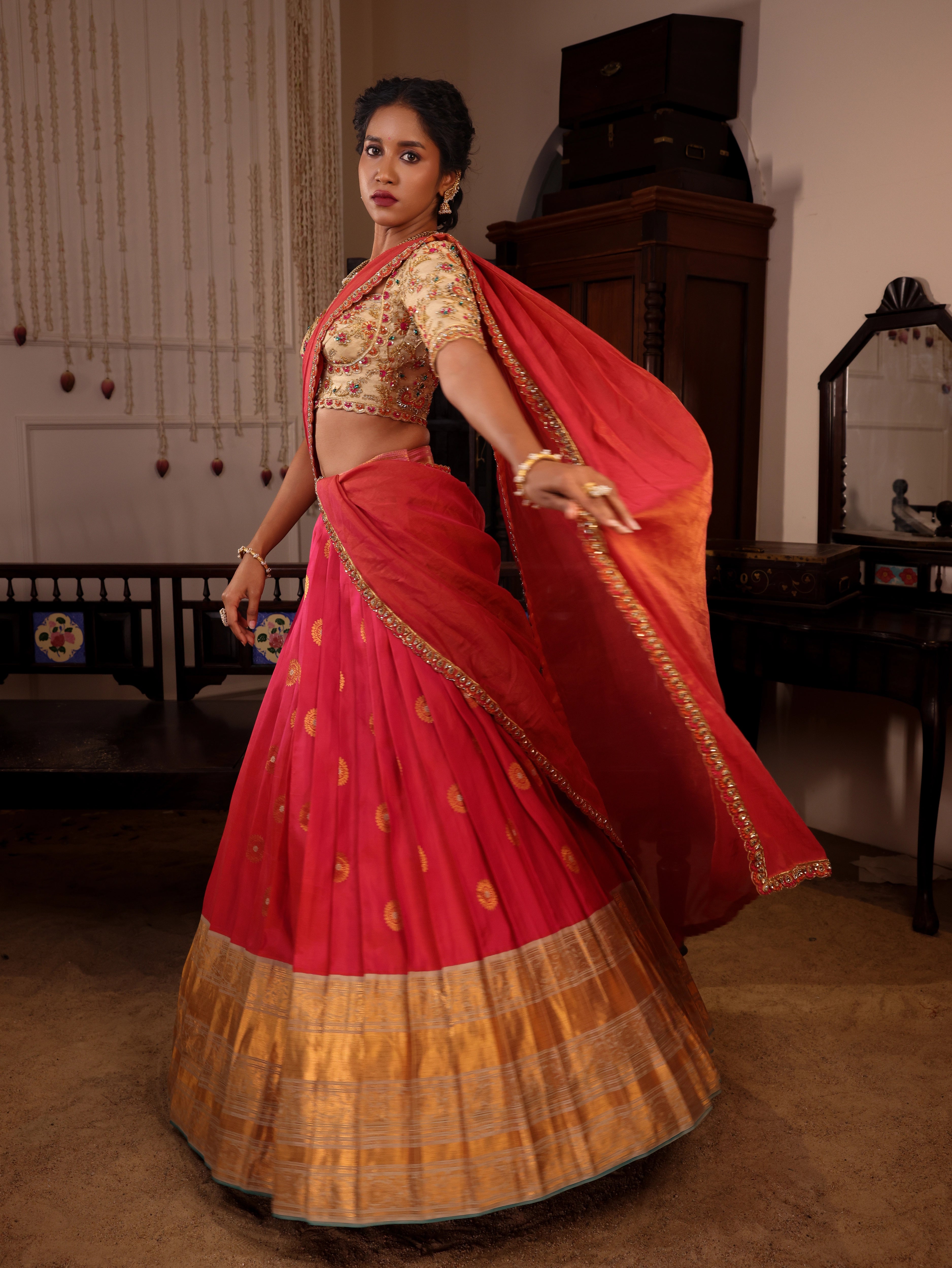 Model Gayathri Dhanasekar twirls in  ivory and pink silk half saree with jewelry by vummidi bangaru jewellers