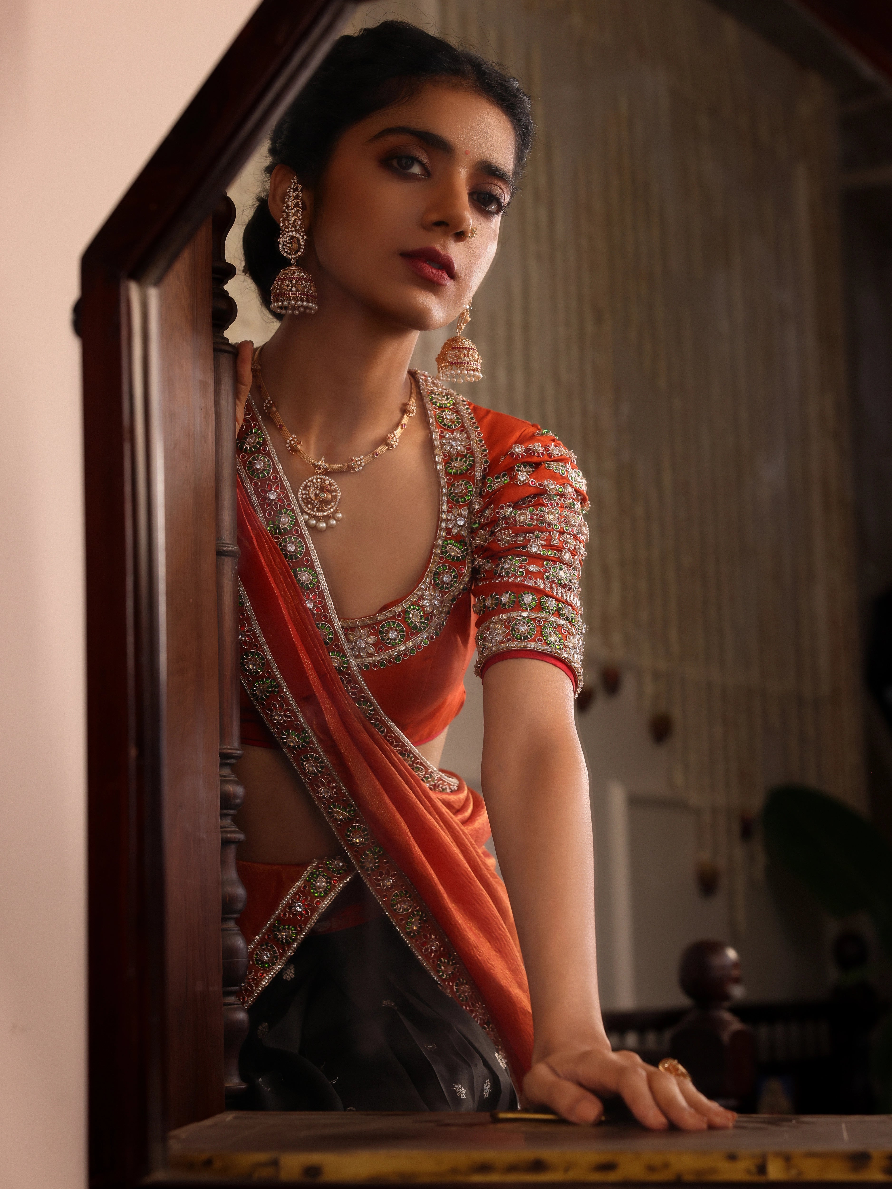 Model Himanshi poses in black & orange kanjeevaram silk half saree with vummidi bangaru jewllery