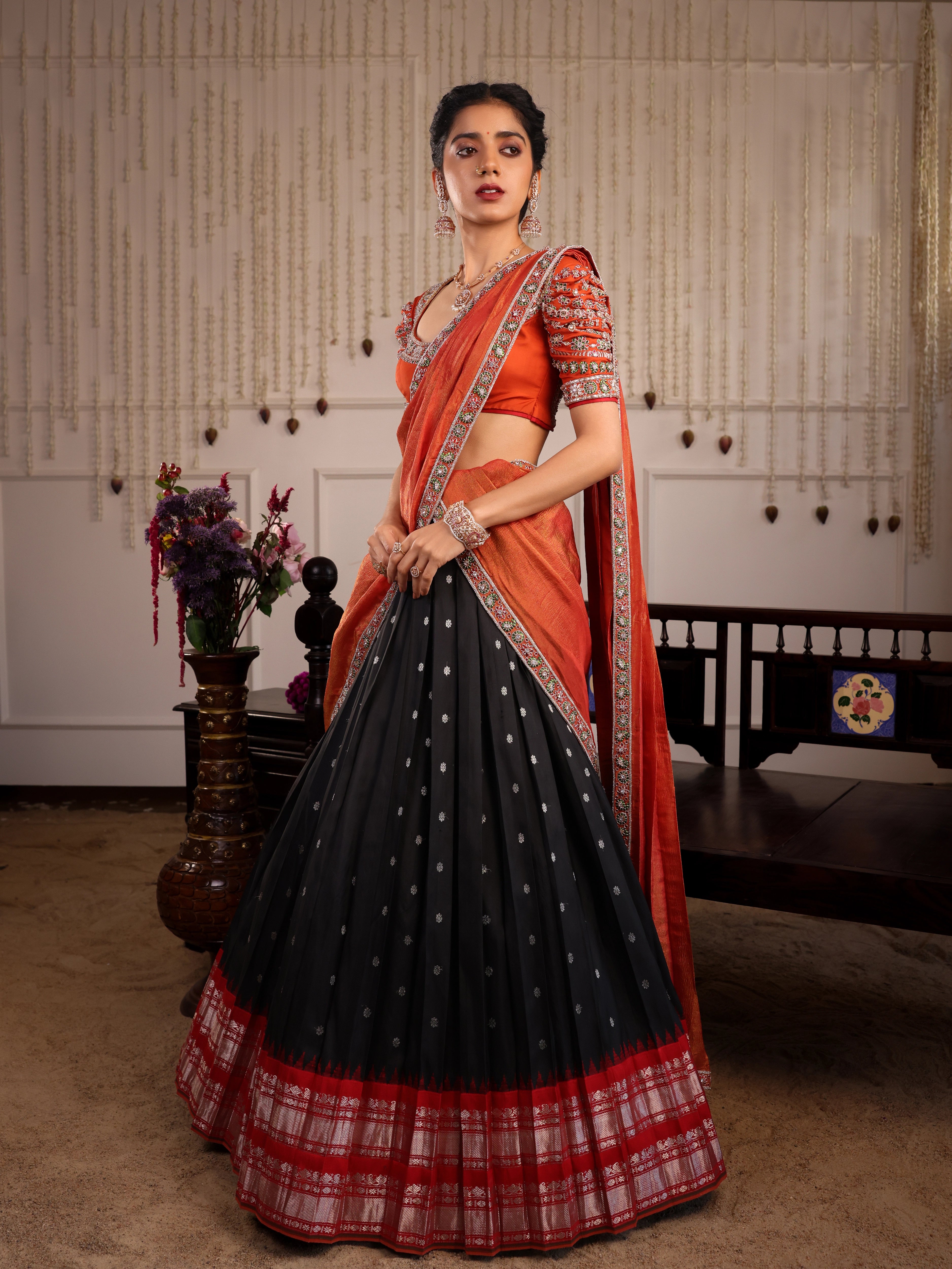 Model Himanshi in a black & orange kanjeevaram silk half saree with vummidi bangaru jewllery