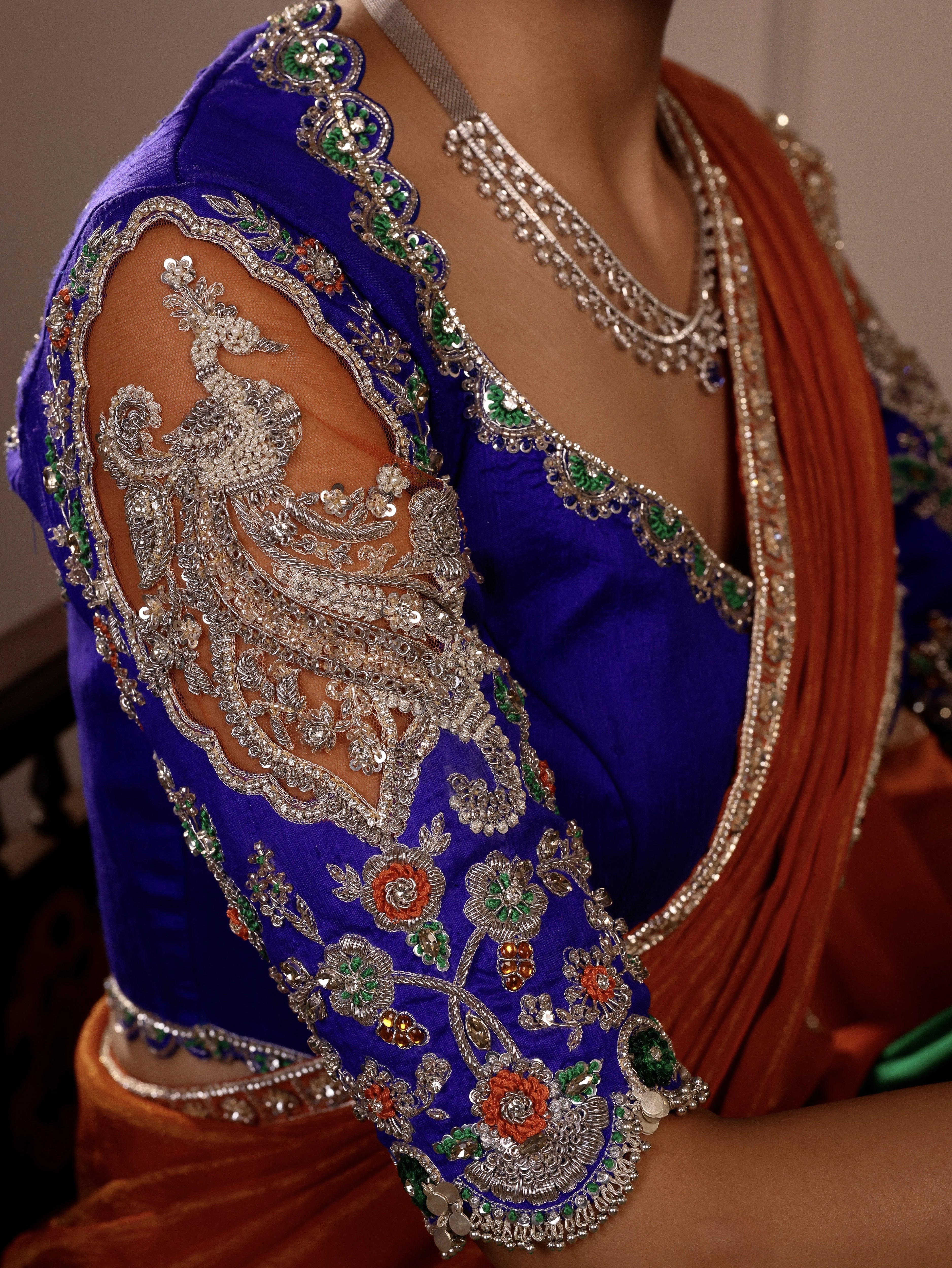 Model Himanshi in orange, blue & green sambalpuri silk half saree blouse sleeve designs with vummidi bangaru jewellery