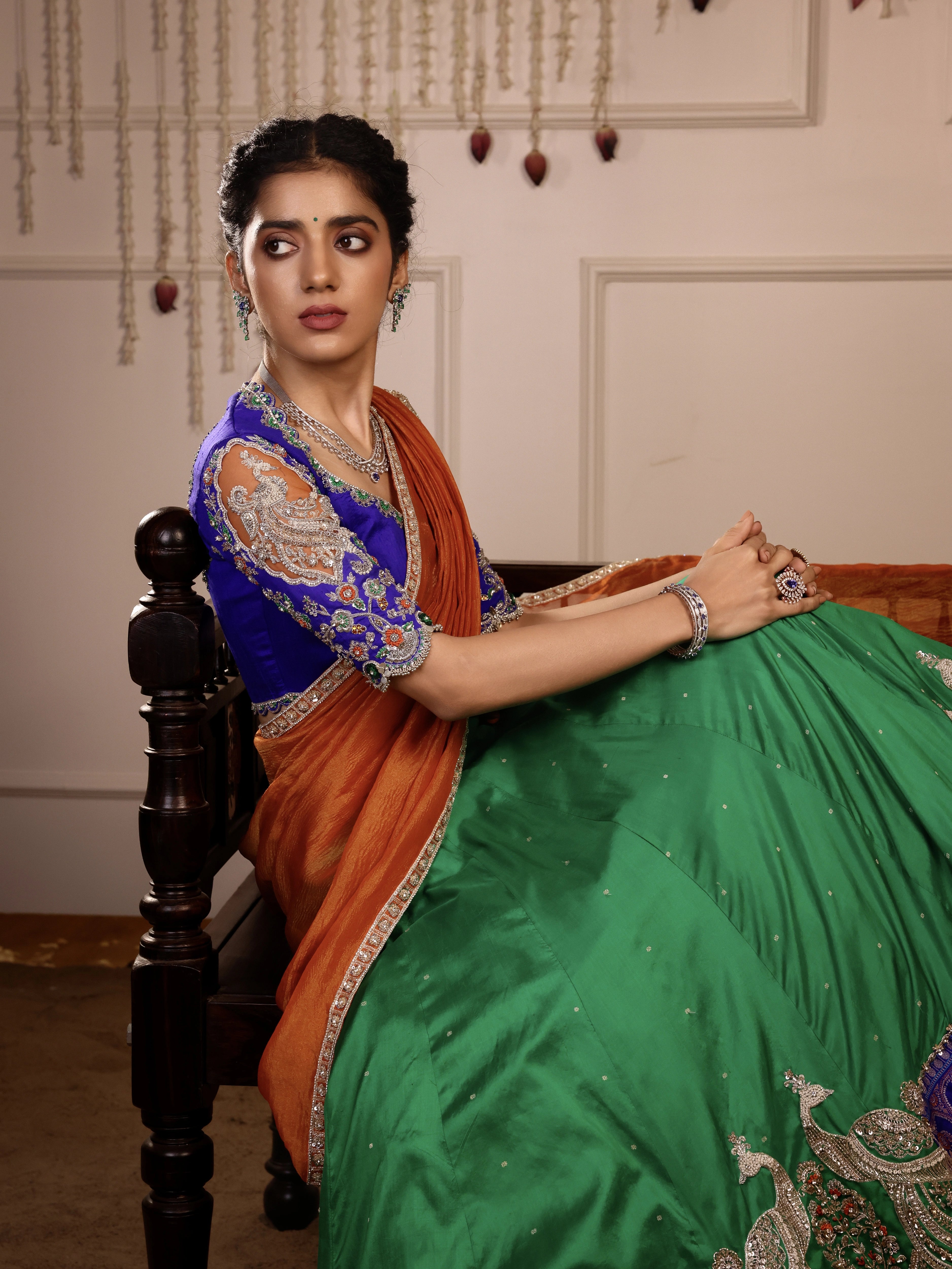 Model Himanshi in orange, blue & green sambalpuri silk half saree blouse sleeve design with vummidi bangaru jewellery