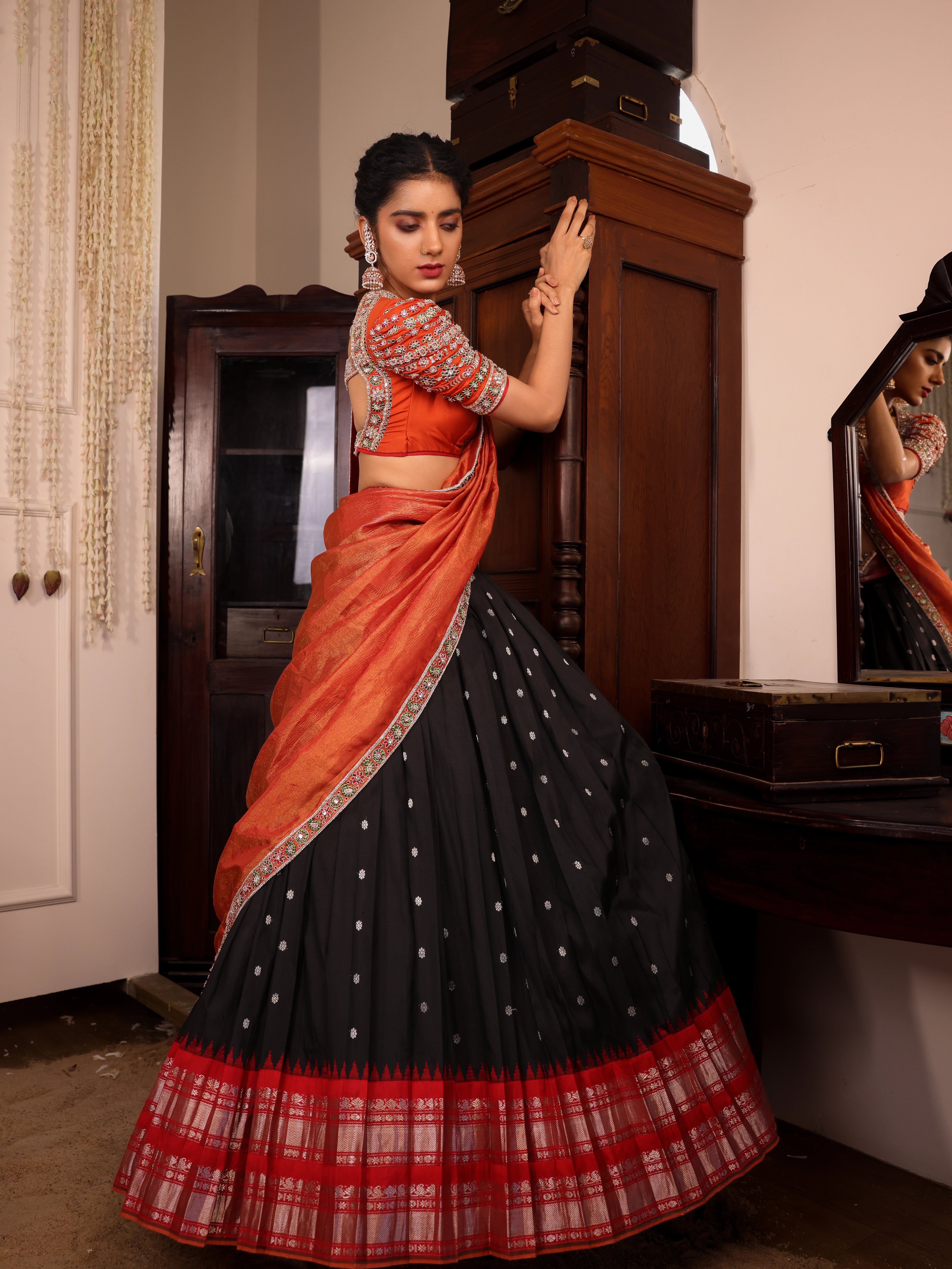 Model Himanshi in black & orange kanjeevaram silk half saree with vummidi bangaru jewllery