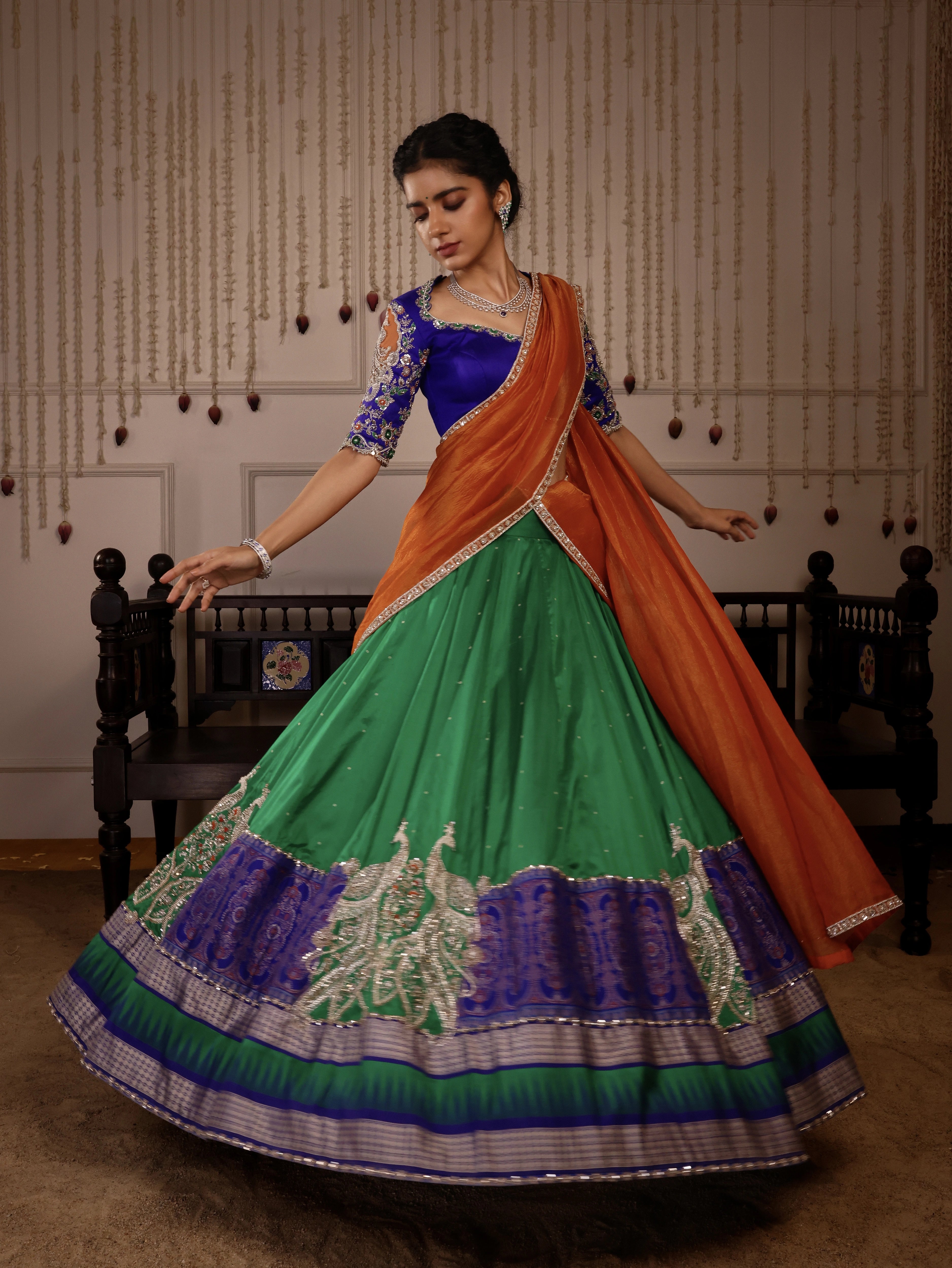 Model Himanshi in orange, blue & green sambalpuri silk half saree with vummidi bangaru jewellery