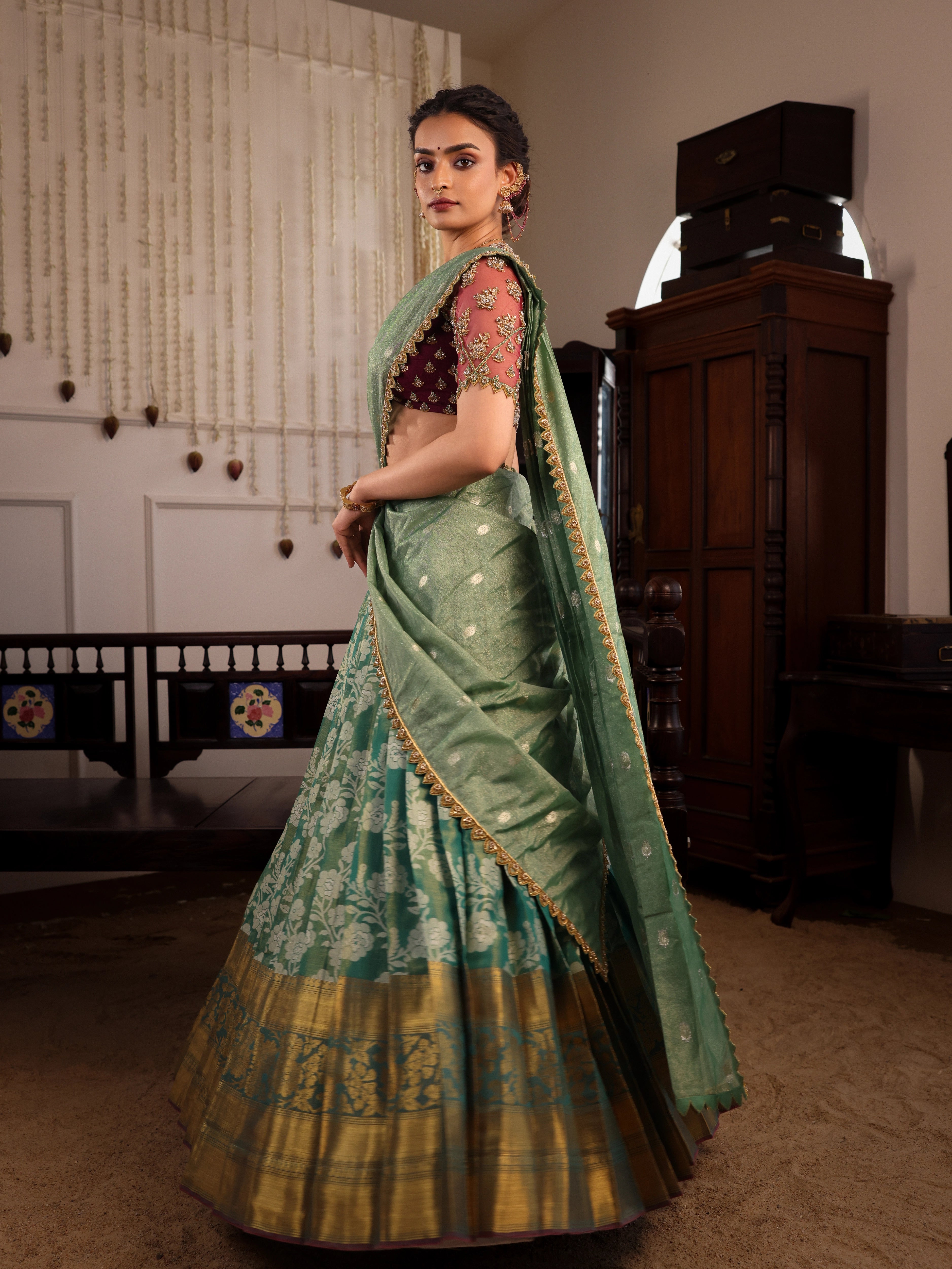 Model Sanskriti Mishra twirls in sea green & wine red jacquard silk half saree with vummidi bangaru jewellery