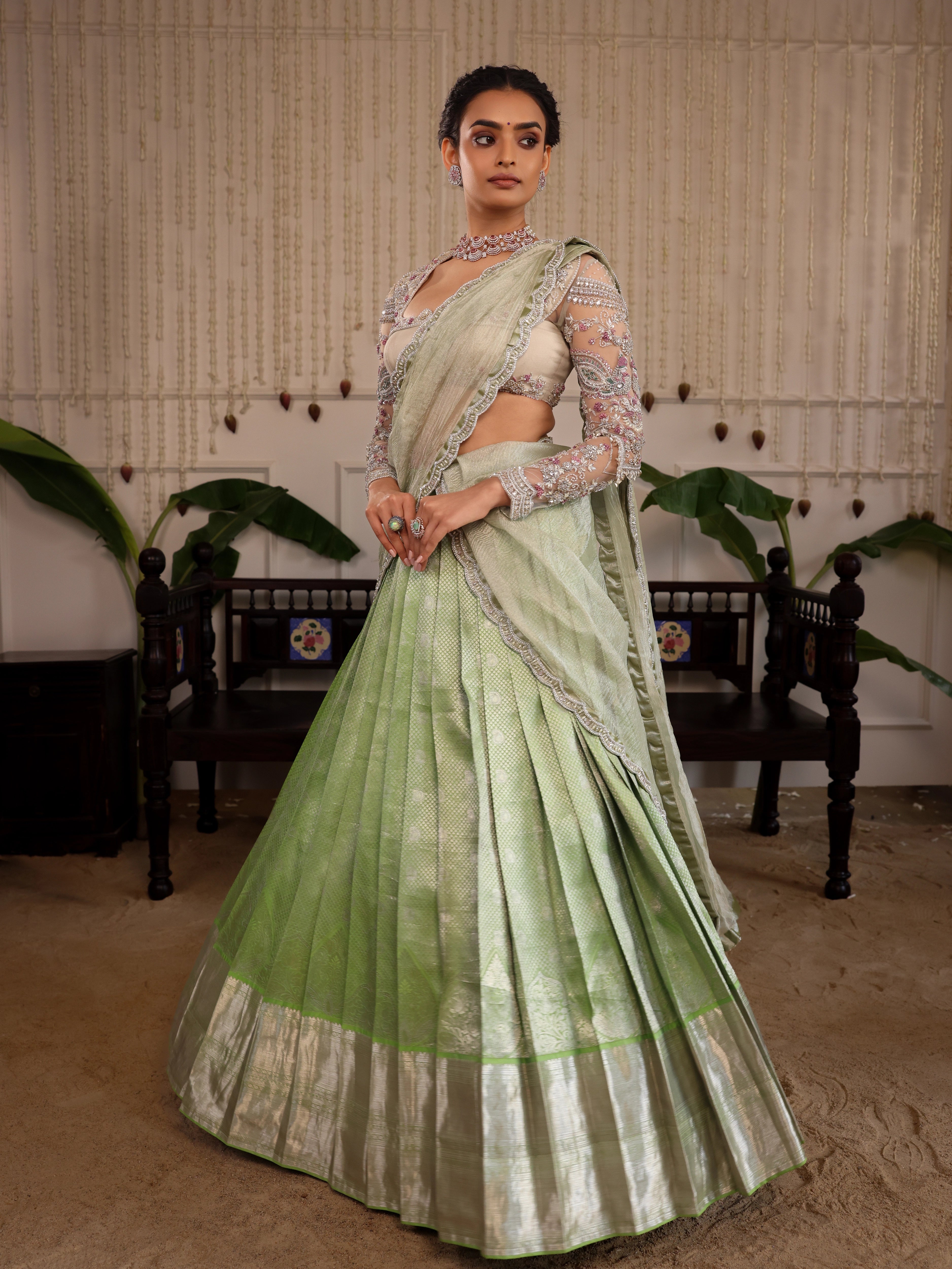 Model Sanskriti Mishra posing in pastel green kanjeevaram silk half saree with vummidi bangaru diamond jewellery