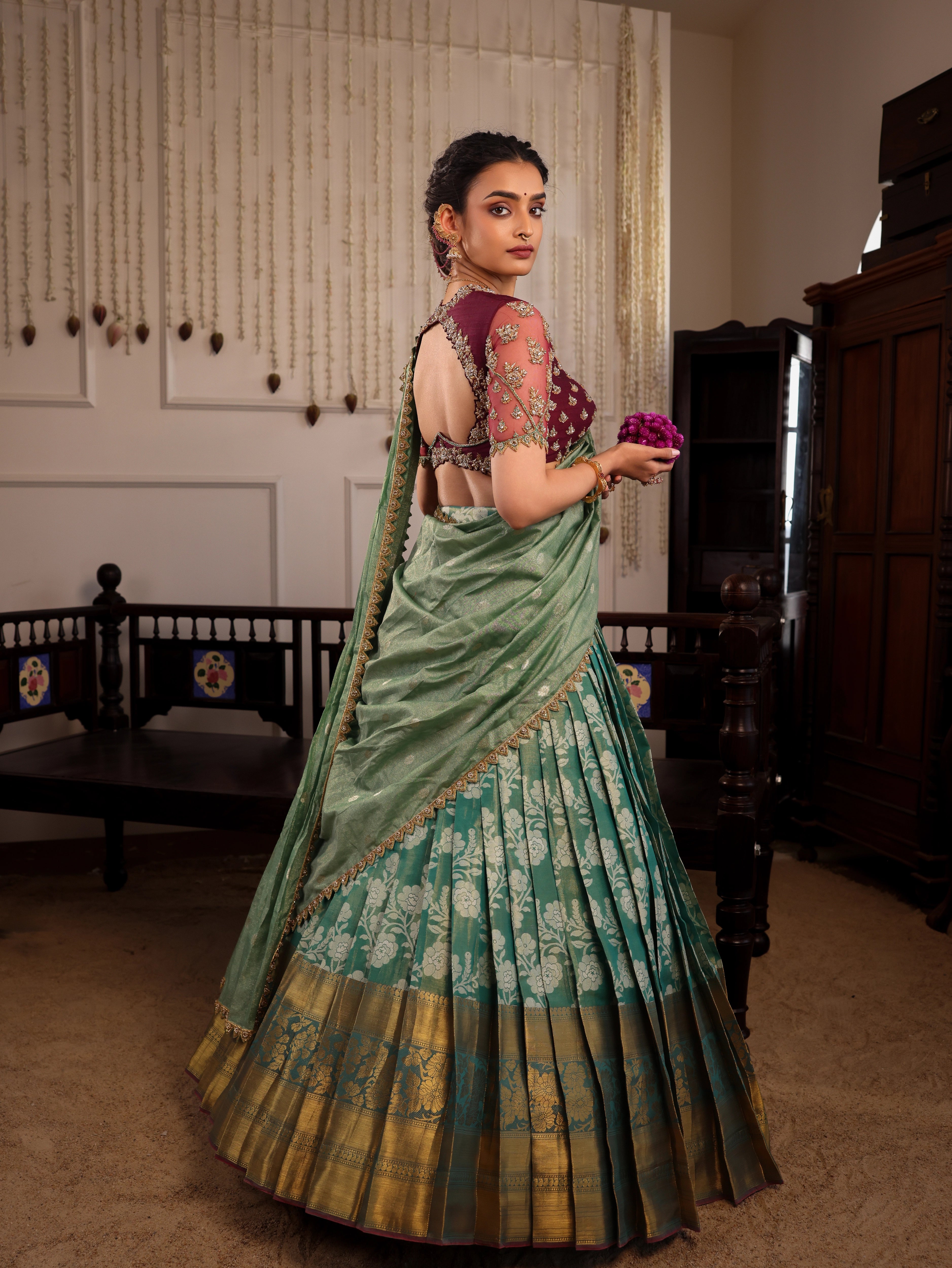 Model Sanskriti Mishra poses in sea green & wine red jacquard silk half saree with vummidi bangaru jewellery