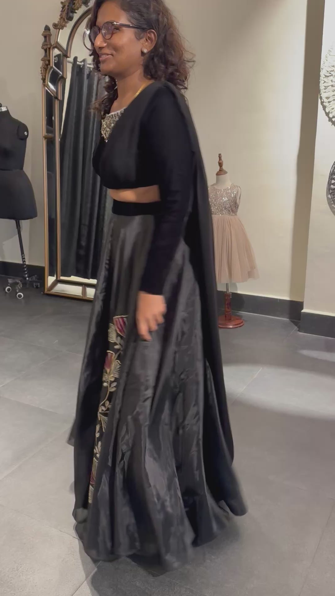 Dr Abinaya twirling in a black dress handcrafted by team Archana Karthick.