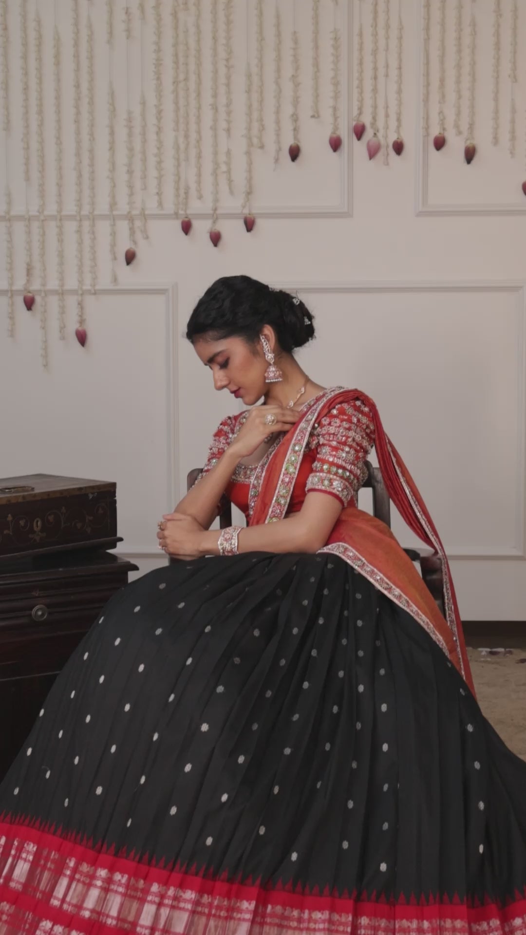 Model Himanshi poses in black & orange kanjeevaram silk half saree music video with vummidi bangaru jewllery