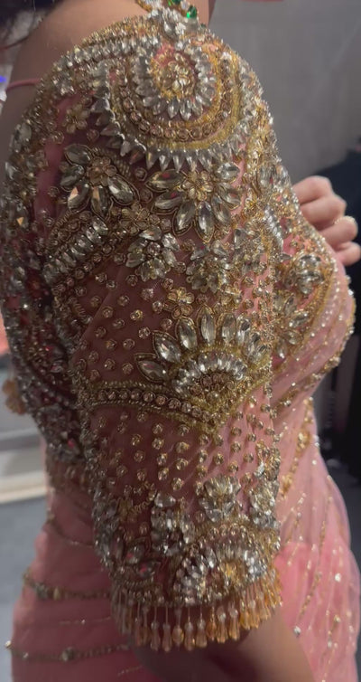 Vaishali from Dubai during fittings in a peach pink saree handcrafted by team Archana Karthick.